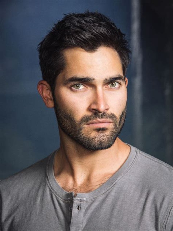 Tyler Hoechlin's Superman grins at an adoring crowd as he steps out of a car in a photo from Superman & Lois season 2